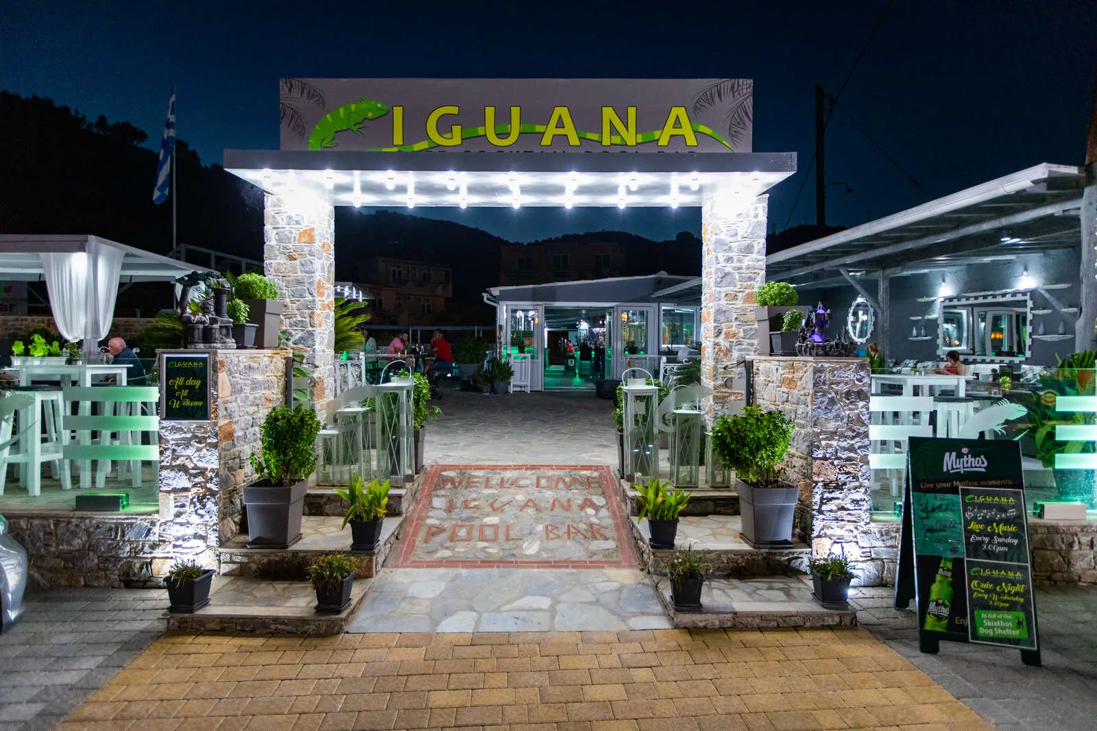 The Iguana entrance and sign lit up at night