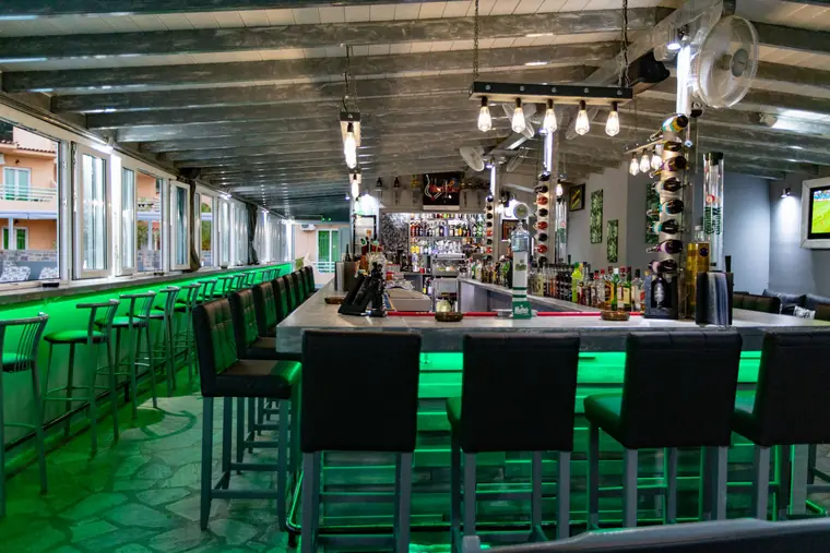 Bar stools under the green lights
