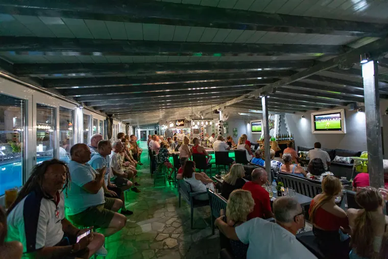 A packed terrace at night