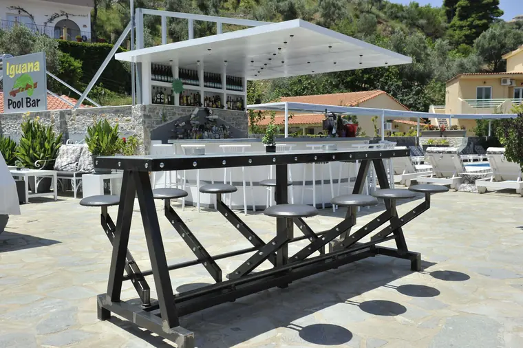 The long wooden table by the pool
