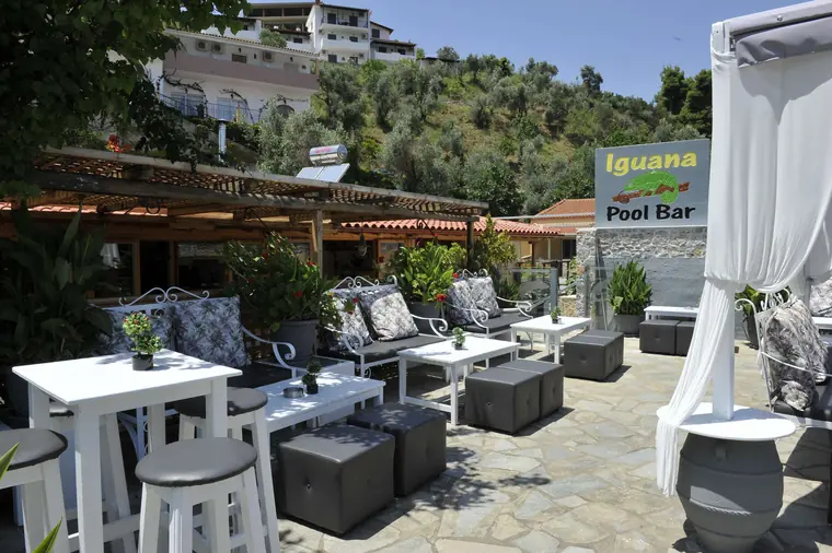 Lounge tables beside the Iguana Pool Bar sign