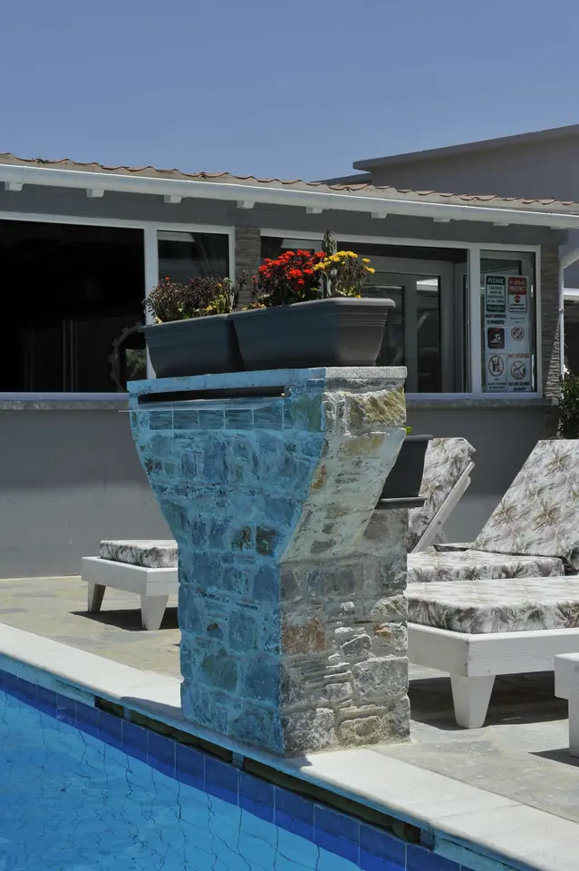 The mosaic waterfall feeding the pool
