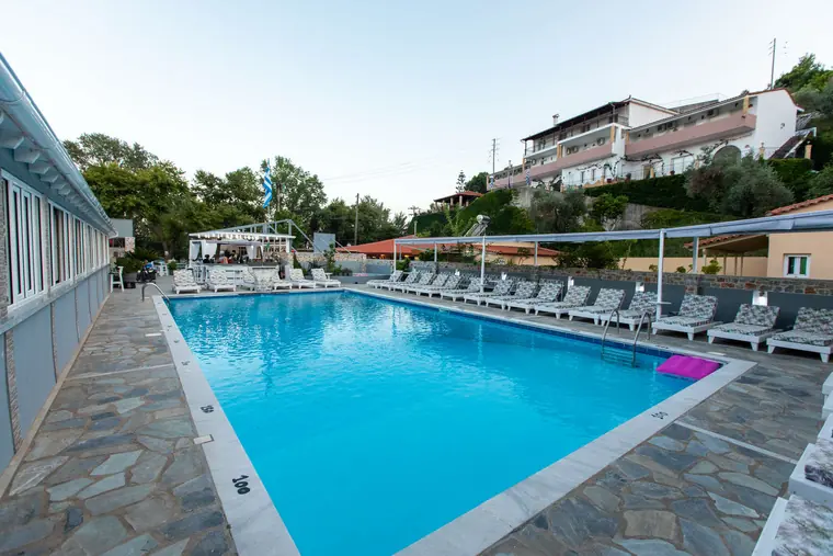 The pool at dusk, with the hillside behind
