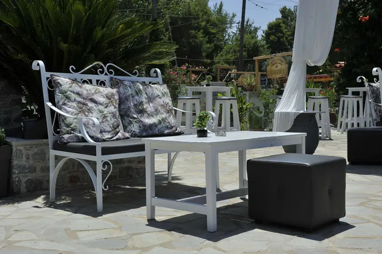 A shady corner with a sofa and table